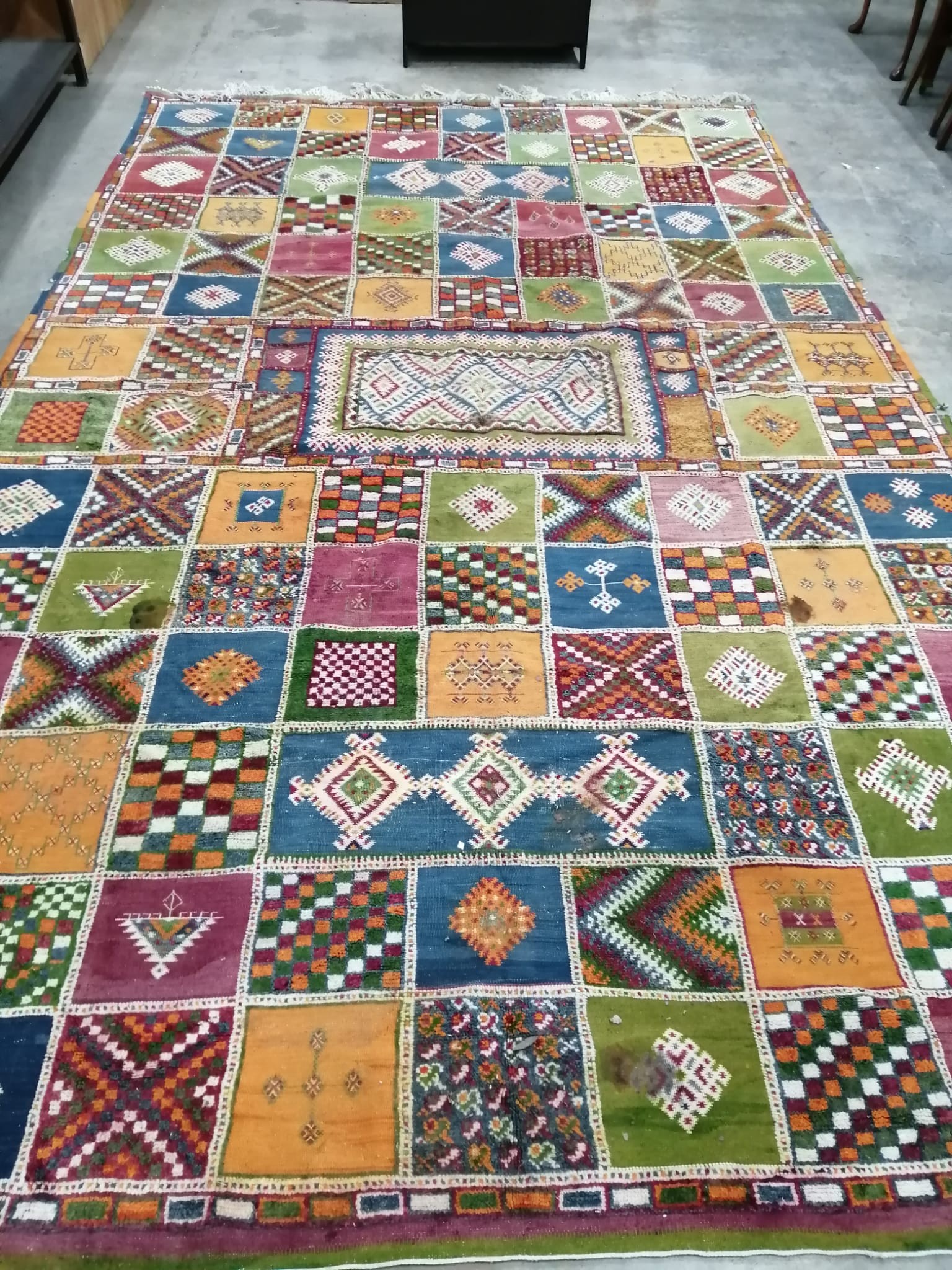 A Caucasian style wool carpet, woven with polychrome geometric squares, 430 x 260cm